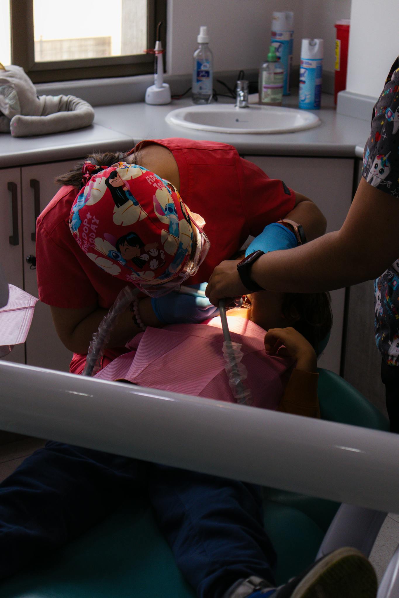 A child receiving dental treatment at a clinic, focusing on oral health care.