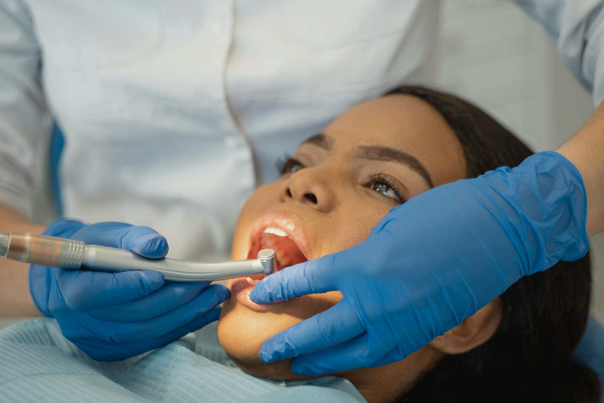 Close-up of a dentist performing a dental treatment on a patient.